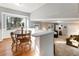 Bright dining area with wooden table set, large window, and view to living room at 6784 Tilton Ln, Peachtree Corners, GA 30360