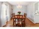 Traditional dining area with wooden table set, chandelier, and view to kitchen at 6784 Tilton Ln, Peachtree Corners, GA 30360