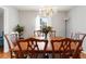 Charming dining room featuring wood table set, decorative chandelier, and large window at 6784 Tilton Ln, Peachtree Corners, GA 30360