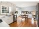 Bright kitchen features white cabinets, stainless steel appliances, and hardwood floors at 6784 Tilton Ln, Peachtree Corners, GA 30360