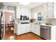 Well-lit kitchen with stainless steel appliances and white cabinets, and view to dining area at 6784 Tilton Ln, Peachtree Corners, GA 30360