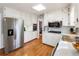 Bright kitchen with stainless steel appliances, white cabinets, and wood floors at 6784 Tilton Ln, Peachtree Corners, GA 30360