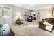 Bright living room boasts neutral carpet, natural light, and access to other rooms and a closet at 6784 Tilton Ln, Peachtree Corners, GA 30360
