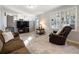 Cozy living room features neutral carpeting, a comfortable couch, and natural light from a large window at 6784 Tilton Ln, Peachtree Corners, GA 30360