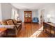 Living room showcasing hardwood floors, china cabinet, and comfortable seating at 6784 Tilton Ln, Peachtree Corners, GA 30360