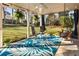 Relaxing covered patio with hanging swing, comfortable seating, and a view of the backyard at 6784 Tilton Ln, Peachtree Corners, GA 30360