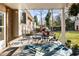 Relaxing covered patio with a dining set, outdoor grill, and access to the yard at 6784 Tilton Ln, Peachtree Corners, GA 30360