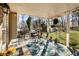 Charming covered patio with a table and chairs, grill, and a beautifully landscaped yard at 6784 Tilton Ln, Peachtree Corners, GA 30360