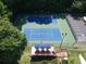 Aerial view of the community tennis courts with shaded seating and nearby parking at 6784 Tilton Ln, Peachtree Corners, GA 30360