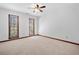 Bedroom with two windows with wood trim, a ceiling fan, and neutral carpet at 1522 Wood Valley Dr, Marietta, GA 30066