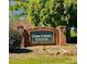 A brick sign welcomes you to Oak Creek Estates, a beautifully landscaped community with mature trees at 1522 Wood Valley Dr, Marietta, GA 30066