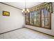 Sunny dining area with tile flooring, view of the trees, and a decorative chandelier at 1522 Wood Valley Dr, Marietta, GA 30066