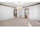 Spacious dining room with neutral carpet, chandelier, and doorway to the kitchen at 1522 Wood Valley Dr, Marietta, GA 30066