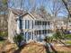 Two-story home featuring a double porch with white railings, complemented by classic blue shutters at 1522 Wood Valley Dr, Marietta, GA 30066