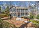 Charming two-story home with a double-decker porch and blue shutters, nestled in a wooded setting at 1522 Wood Valley Dr, Marietta, GA 30066