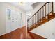 Bright foyer featuring hardwood floors, staircase with wood railing, and an entry door with sidelights at 1522 Wood Valley Dr, Marietta, GA 30066