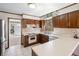 Functional kitchen with stainless steel refrigerator, wood cabinets, and lots of counter space at 1522 Wood Valley Dr, Marietta, GA 30066