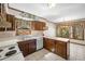 Charming kitchen with a view, features wood cabinets, and an adjoining dining area at 1522 Wood Valley Dr, Marietta, GA 30066