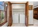 Convenient laundry room with full-size washer and dryer, natural light, and wood doors at 1522 Wood Valley Dr, Marietta, GA 30066