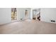 Bright living room featuring neutral carpet and large windows with backyard views at 1522 Wood Valley Dr, Marietta, GA 30066