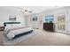 Staged main bedroom features a door to the outside, neutral carpet, and art at 1522 Wood Valley Dr, Marietta, GA 30066