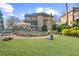 Lush backyard showcases a stone patio, a sparkling pool, and mature landscaping at 2260 Wood Falls Dr, Cumming, GA 30041