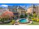 Beautiful backyard with a freeform pool, lush landscaping, and screened porch at 2260 Wood Falls Dr, Cumming, GA 30041