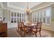 Bright dining room with hardwood floors, a chandelier, and large windows with plantation shutters at 2260 Wood Falls Dr, Cumming, GA 30041