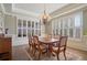 Formal dining room with wood floors, shuttered windows, and stylish chandelier at 2260 Wood Falls Dr, Cumming, GA 30041