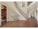 Spacious foyer with curved staircase, hardwood floors, and access to a study and living areas, offering a warm welcome at 2260 Wood Falls Dr, Cumming, GA 30041