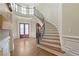 Elegant foyer with a sweeping staircase, hardwood floors, and custom millwork creating a grand entrance at 2260 Wood Falls Dr, Cumming, GA 30041