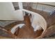 High-angle view of a stunning foyer showcasing a curved staircase, hardwood floors, and elegant architectural details at 2260 Wood Falls Dr, Cumming, GA 30041