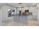 Neutral kitchen with island, under cabinet lighting, and view to the outdoor patio area at 2260 Wood Falls Dr, Cumming, GA 30041