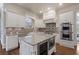 Well-equipped kitchen featuring granite countertops, custom cabinetry, a wine fridge, and stainless steel appliances at 2260 Wood Falls Dr, Cumming, GA 30041