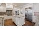 Gourmet kitchen with custom white cabinets, granite countertops, stainless steel appliances, and an island at 2260 Wood Falls Dr, Cumming, GA 30041
