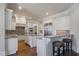 A spacious kitchen features custom cabinetry, stainless steel appliances, granite countertops, and a breakfast bar with seating at 2260 Wood Falls Dr, Cumming, GA 30041