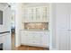 A kitchen bar area with granite countertop, and custom cabinets at 2260 Wood Falls Dr, Cumming, GA 30041