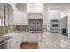 A gourmet kitchen with a granite-topped island, modern stainless steel appliances, and custom white cabinets at 2260 Wood Falls Dr, Cumming, GA 30041