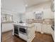 A gourmet kitchen featuring custom cabinets, stainless steel appliances, granite countertops, and island with wine cooler at 2260 Wood Falls Dr, Cumming, GA 30041