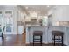 Open-concept kitchen with a breakfast bar, stainless appliances, granite countertops, and access to the outdoor space at 2260 Wood Falls Dr, Cumming, GA 30041