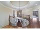 Upstairs landing with wrought iron railing and a view of the foyer chandelier at 2260 Wood Falls Dr, Cumming, GA 30041