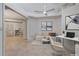 A chic living room features a comfy sofa, artwork, desk, and stone tile flooring at 2260 Wood Falls Dr, Cumming, GA 30041
