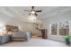 Serene main bedroom with tray ceiling, sitting area, and large windows with outdoor views at 2260 Wood Falls Dr, Cumming, GA 30041