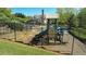 Community playground featuring a slide and climbing area, set against a backdrop of lush landscaping and upscale homes at 2260 Wood Falls Dr, Cumming, GA 30041