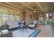 Inviting screened porch offers outdoor comfort with cozy seating and a ceiling fan at 2260 Wood Falls Dr, Cumming, GA 30041