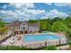 Aerial view showcasing a large swimming pool, lounge chairs and umbrellas offering a resort-style living experience at 2260 Wood Falls Dr, Cumming, GA 30041