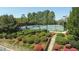 Lush landscaping surrounds well-maintained tennis courts, offering a picturesque setting for friendly competition at 2260 Wood Falls Dr, Cumming, GA 30041