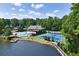 Aerial view of community pool, tennis courts, and lake, surrounded by mature trees and landscaping at 3605 Wood Valley Ne Ct, Brookhaven, GA 30319