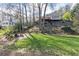 Expansive backyard featuring a fire pit and Adirondack chairs, with a view of the home's elevated deck at 3605 Wood Valley Ne Ct, Brookhaven, GA 30319