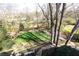 Backyard featuring lush green space and a stone patio with mature trees, offering scenic views at 3605 Wood Valley Ne Ct, Brookhaven, GA 30319